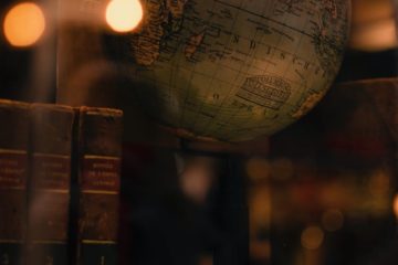 old books and globe in library